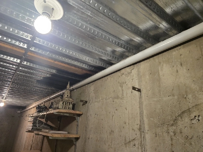 Sump pump discharge line in a North Ogden cold storage room